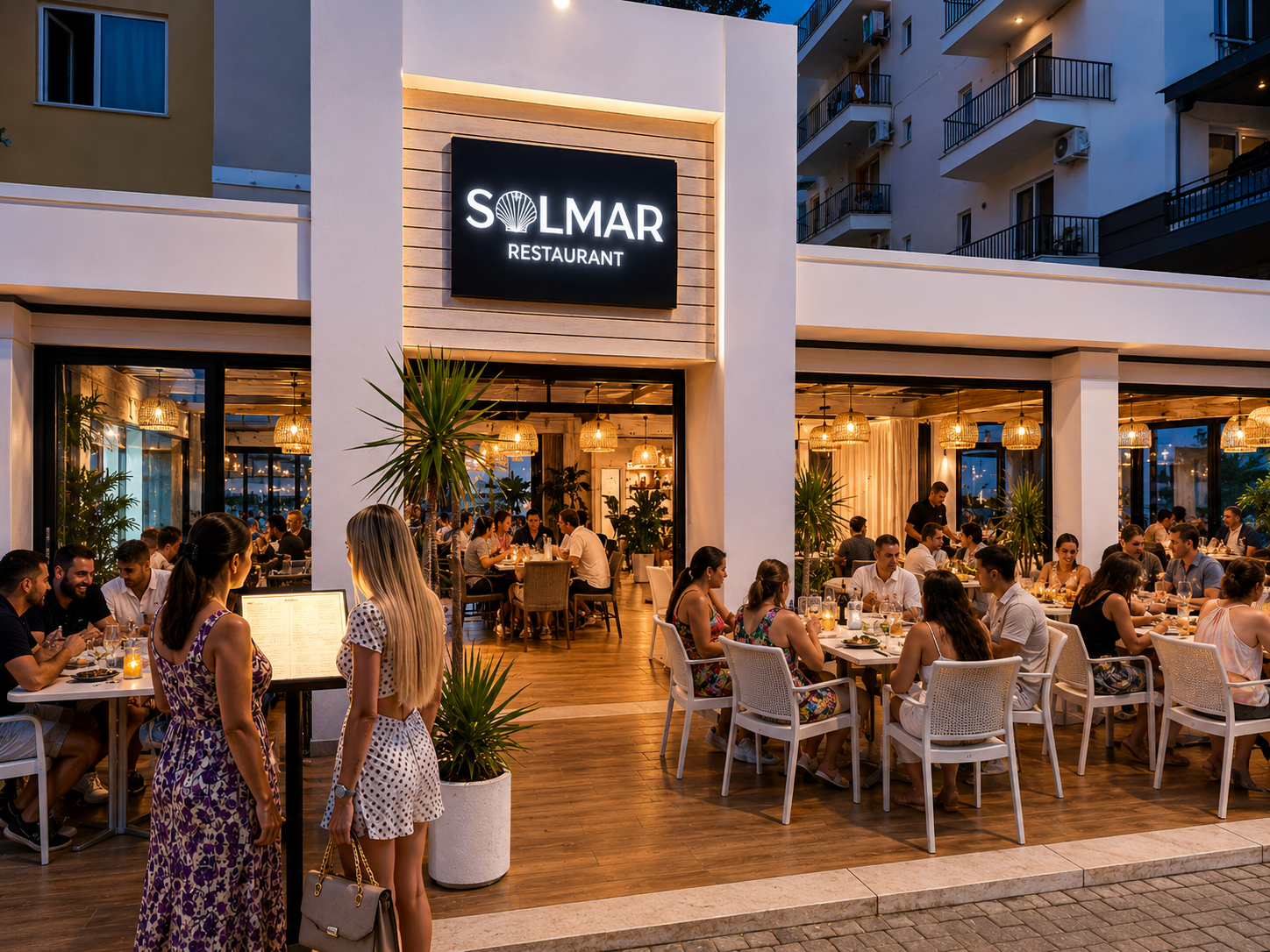 Solmar Restaurant Shengjin exterior at night with guests enjoying seafood by the sea